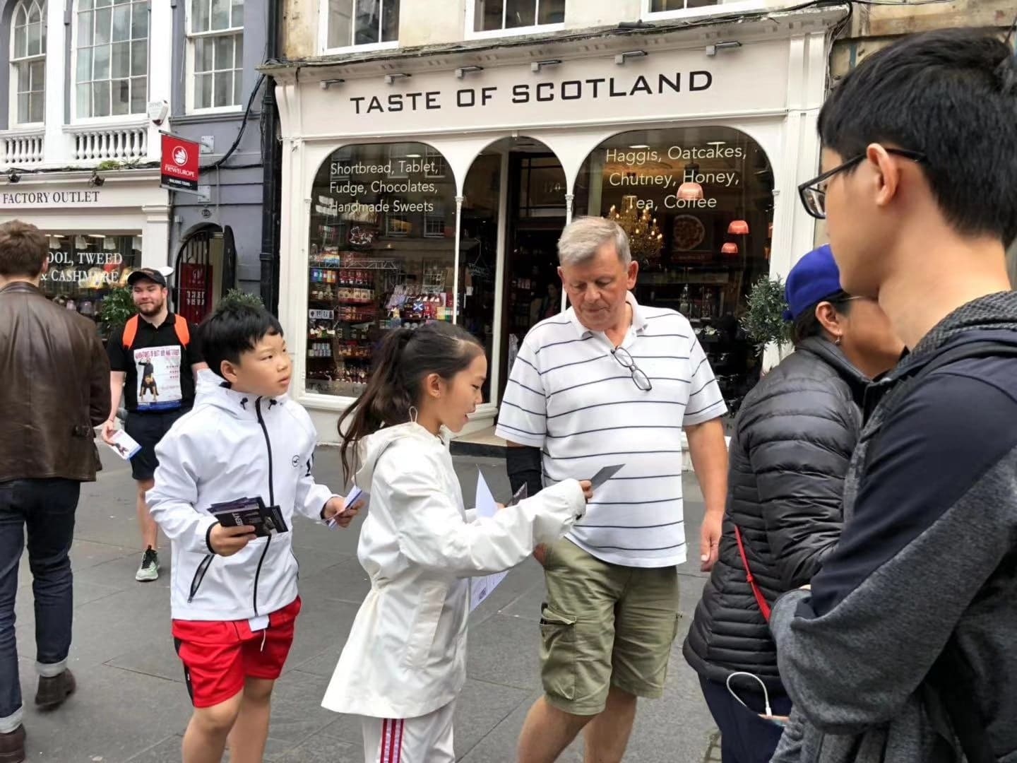 Here Dance students handing out flyers for their show to passers-by on the Royal Mile