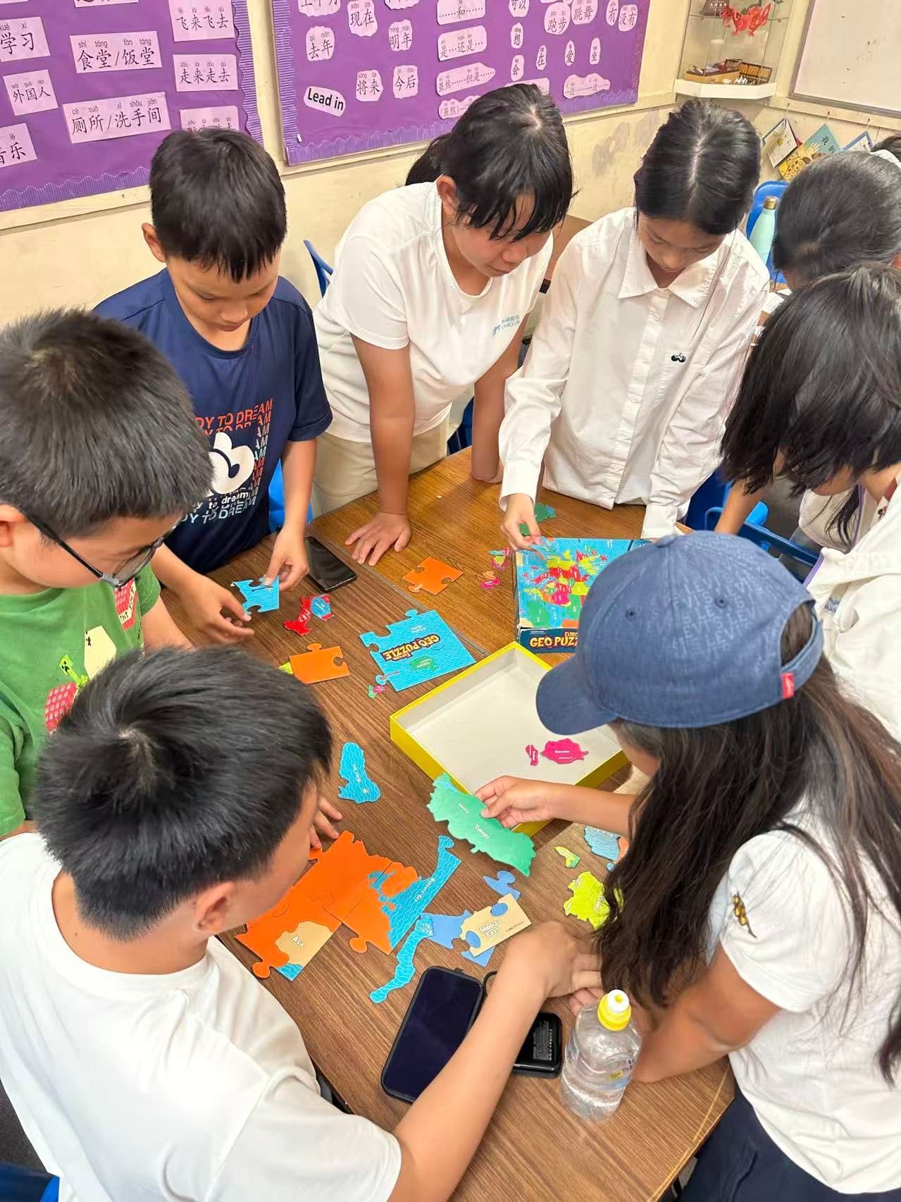 Visiting students and UK buddies working together on a group activity at a table